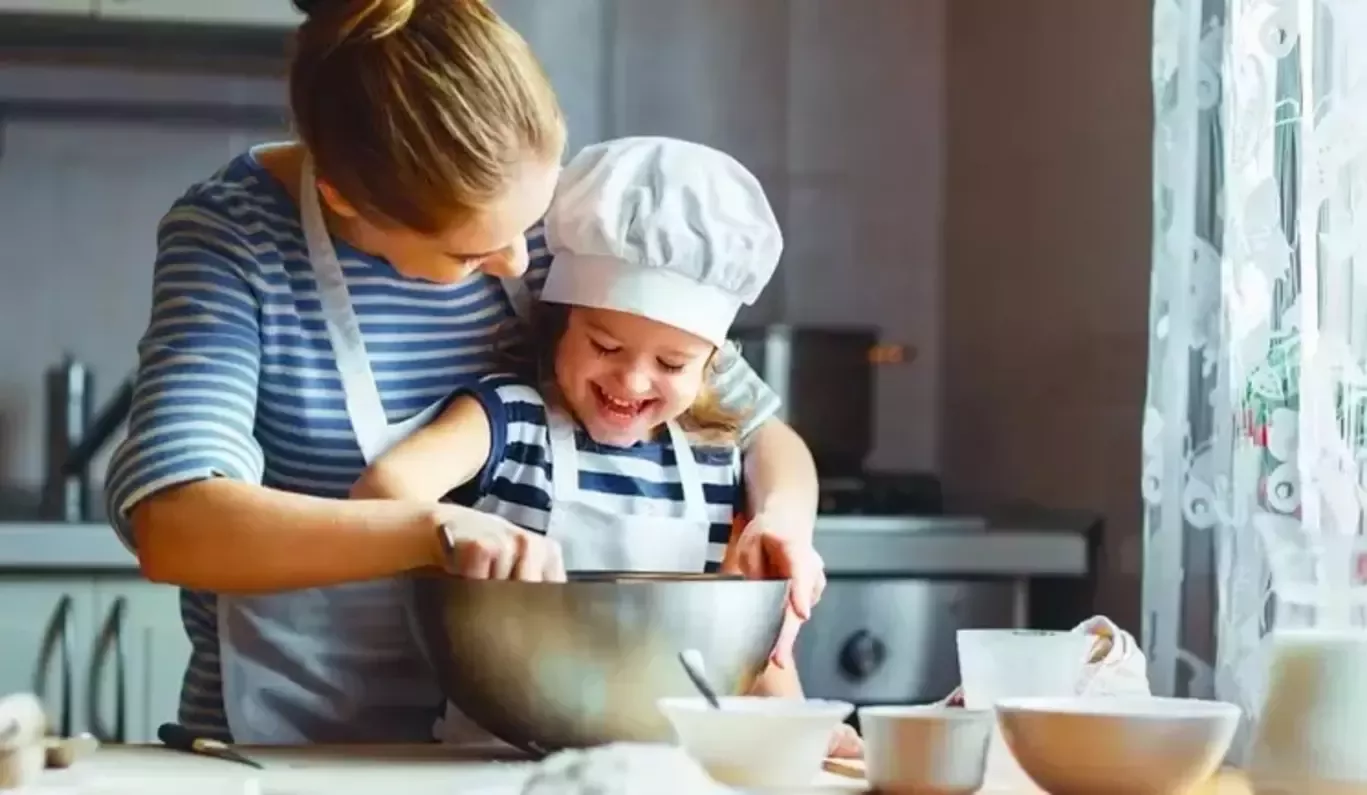 child and adult in a kitchen
